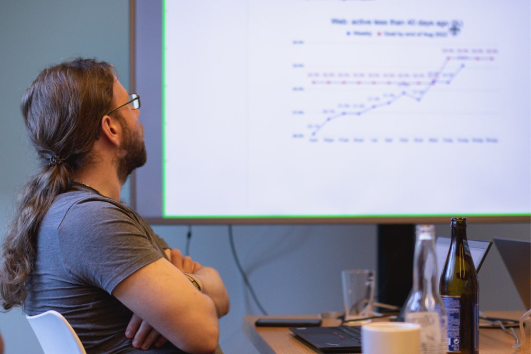 A Maritime Optima employee watching a presentation.